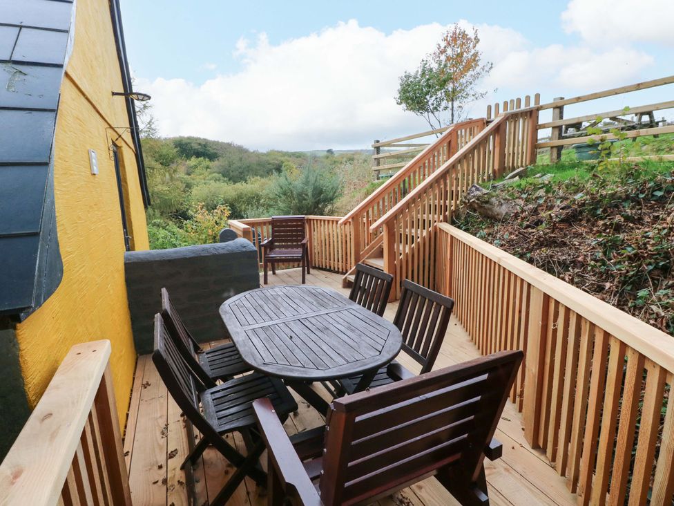 A deck with a table and chairs at Pendre Barn in Star near Cenarth