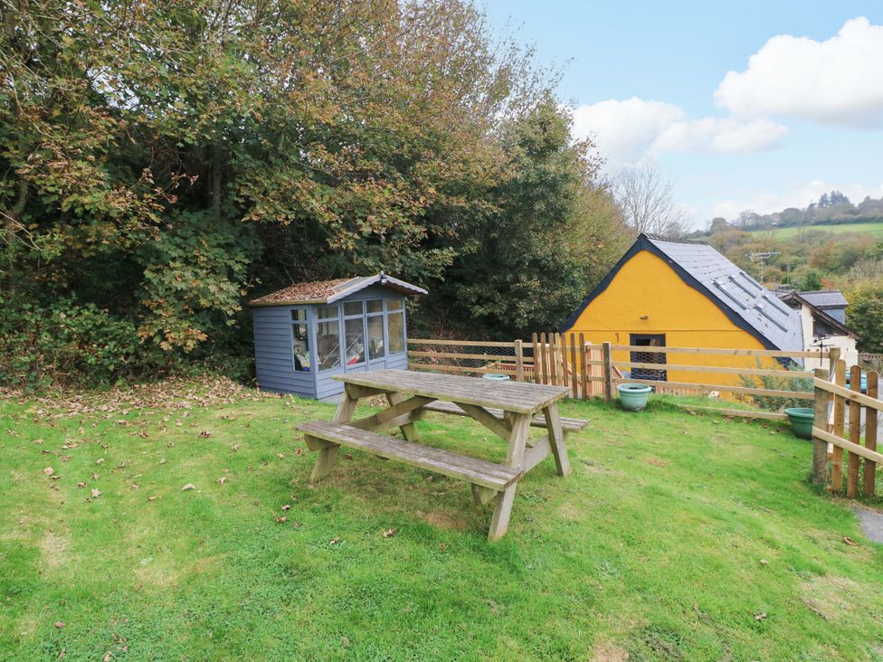 A picnic table and shed in a garden at Pendre Barn Star near Cenarth