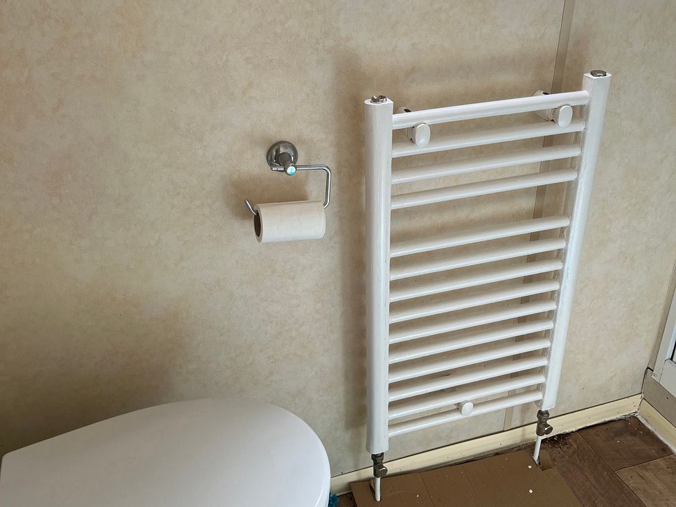 A bathroom with a toilet and a radiator at Sylvan in Builth Wells
