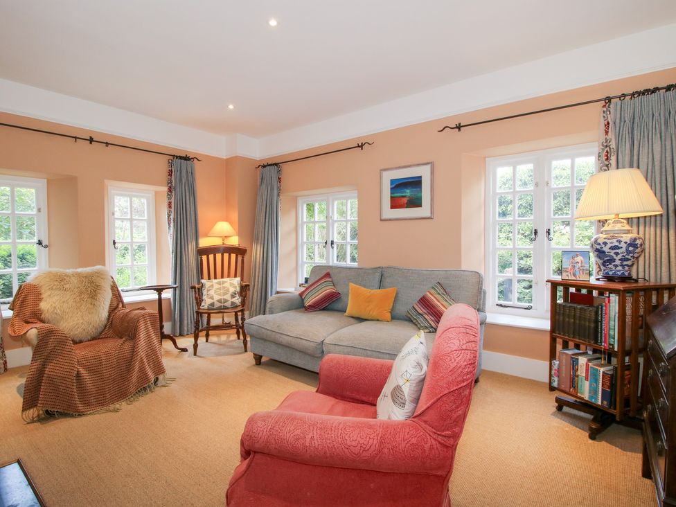 A living room with a sofa and armchair at Uplands House in Ledbury
