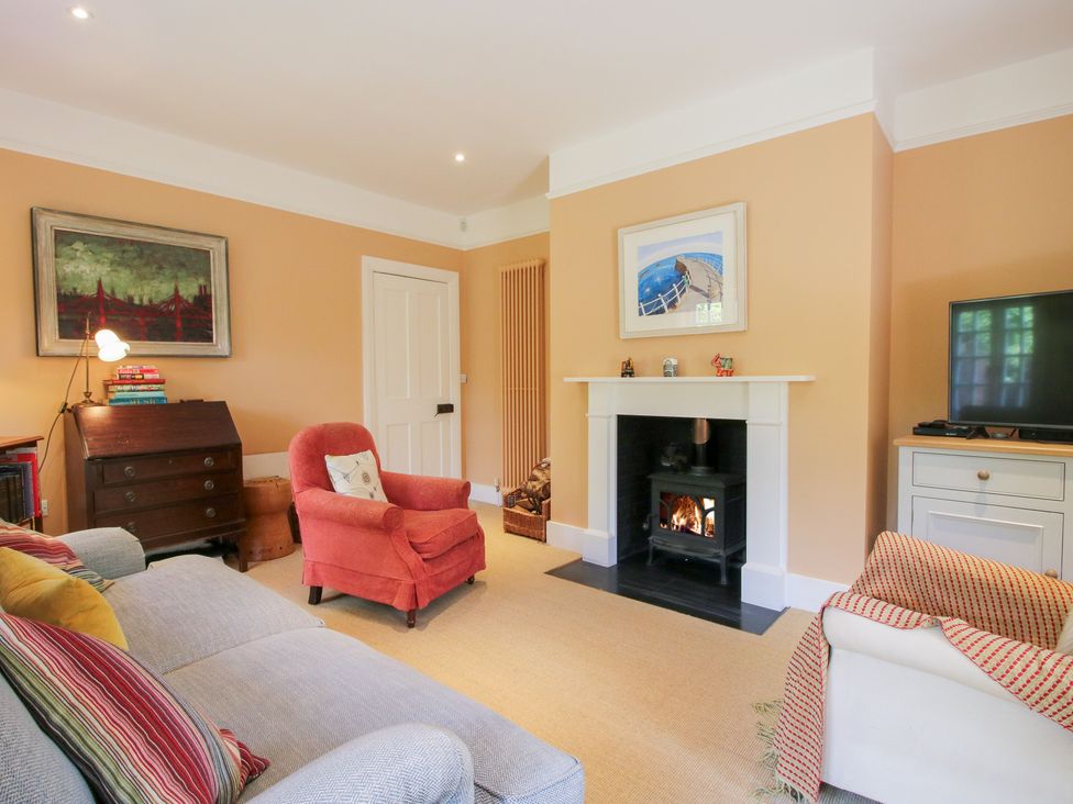 A living room with a fireplace and a television at Uplands House Ledbury
