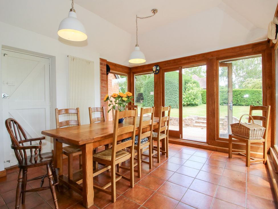 A dining room with a table and chairs at Uplands House Ledbury