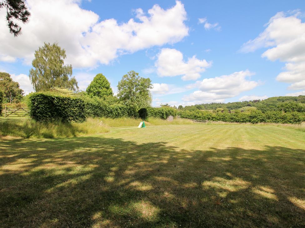 A garden with trees and grass at Uplands House in Ledbury