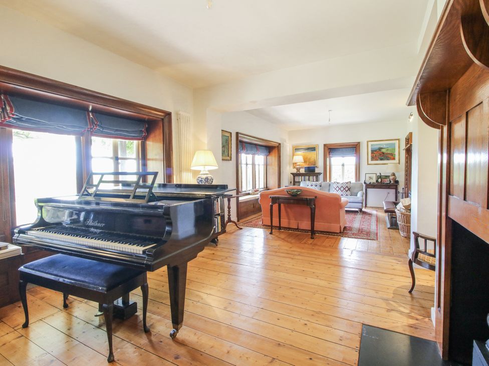 A living room with a piano and sofa at Uplands Dowerhouse Wellington Heath near Ledbury