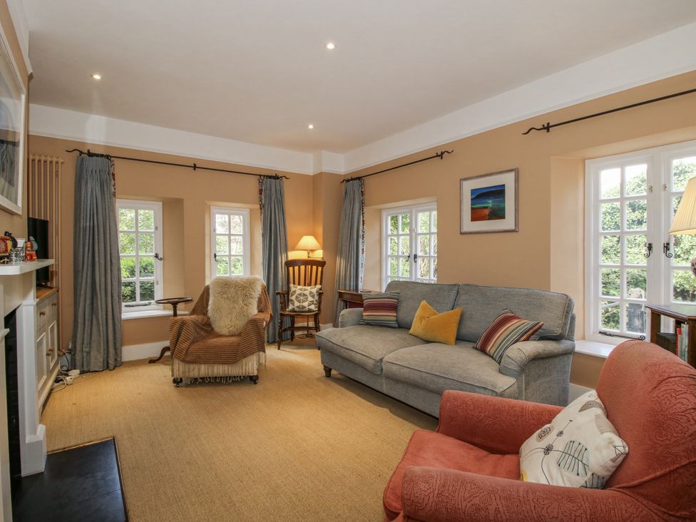 A living room with a sofa and armchair at Uplands Dowerhouse Wellington Heath near Ledbury