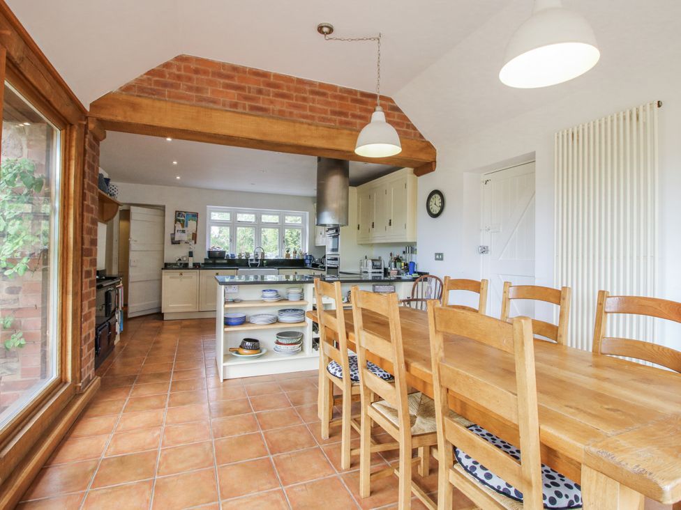A kitchen with dining table and chairs at Uplands Dowerhouse Wellington Heath near Ledbury