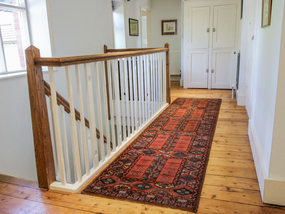 A hallway with a carpet and a staircase at Uplands Dowerhouse in Wellington Heath near Ledbury