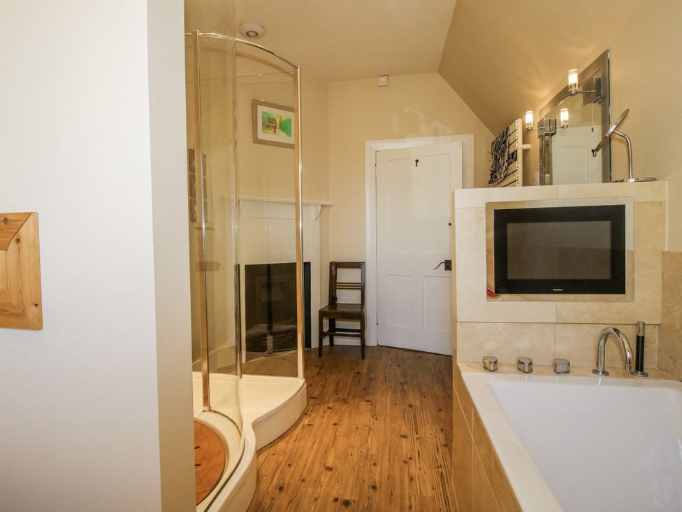 A bathroom with a shower, bathtub, and sink at Uplands Dowerhouse in Wellington Heath near Ledbury