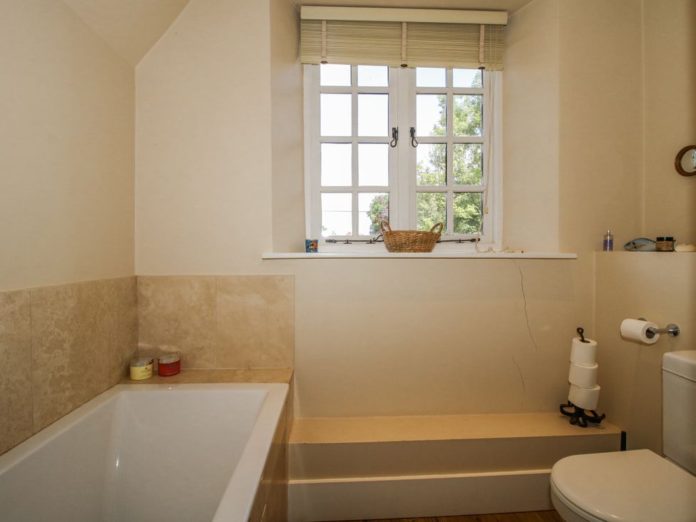 A bathroom with a bathtub and toilet at Uplands Dowerhouse in Wellington Heath near Ledbury