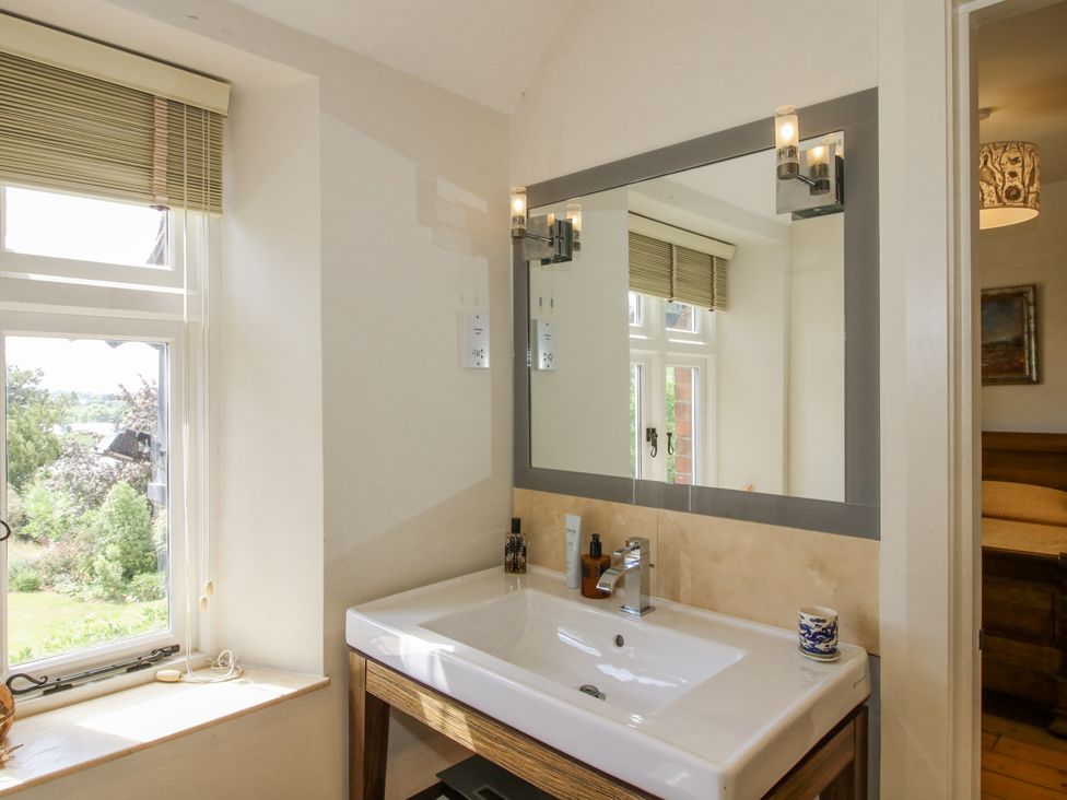 A bathroom with a sink and mirror at Uplands Dowerhouse Wellington Heath near Ledbury