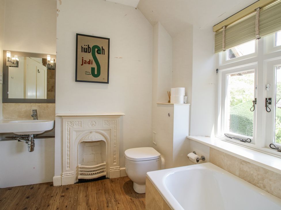 A bathroom with a sink, tub and toilet at Uplands Dowerhouse in Wellington Heath near Ledbury