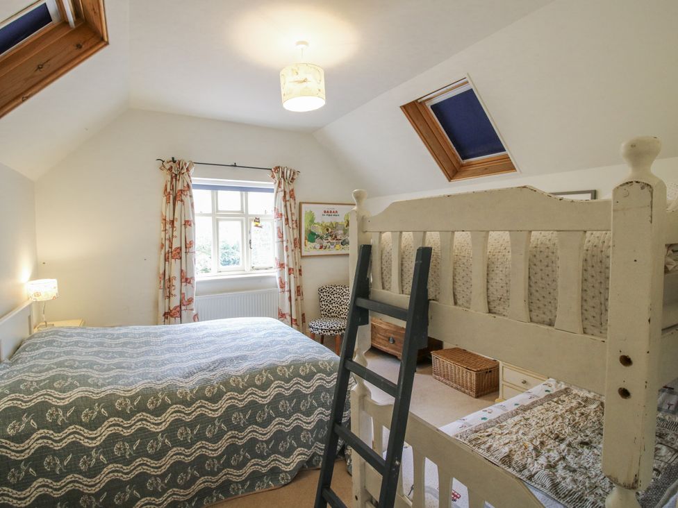 A bedroom with a double bed and a bunk bed at Uplands Dowerhouse Wellington Heath near Ledbury