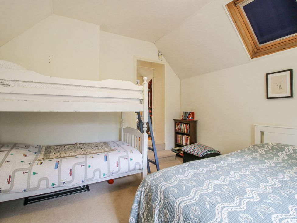 A bedroom with a bunk bed and a single bed at Uplands Dowerhouse in Wellington Heath near Ledbury