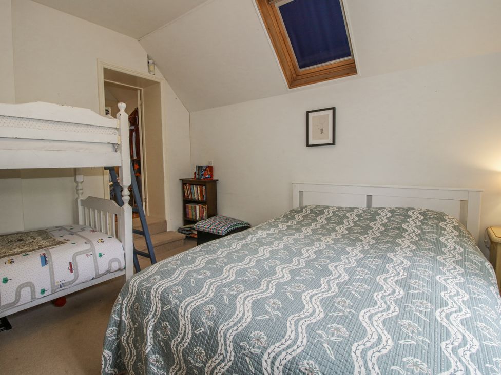 A bedroom with a bunk bed and a double bed at Uplands Dowerhouse Wellington Heath near Ledbury