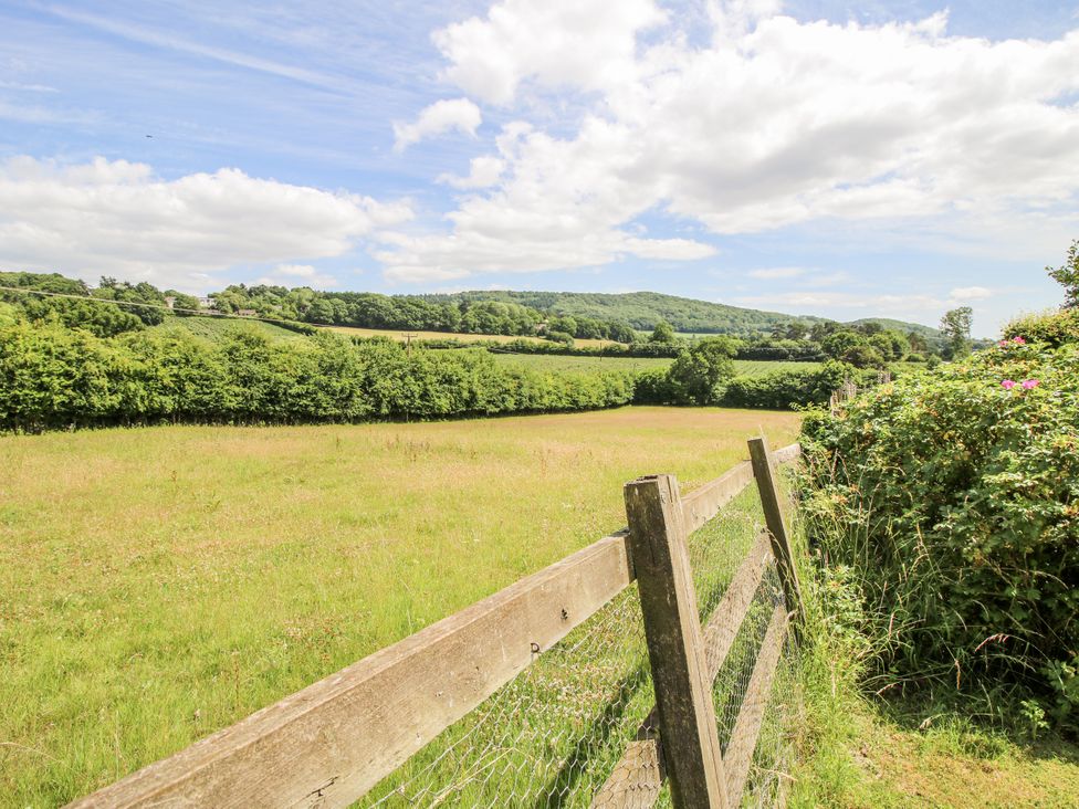 A view of a field with a wooden fence at Uplands Dowerhouse Wellington Heath near Ledbury