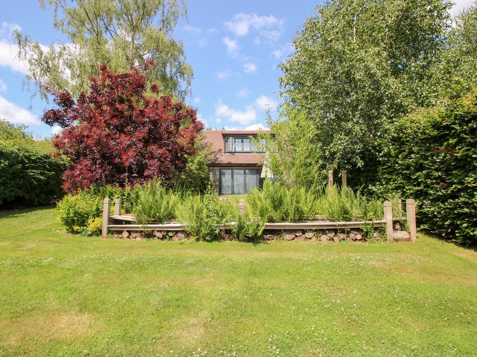 A house with a garden and trees at Uplands Cottage in Ledbury
