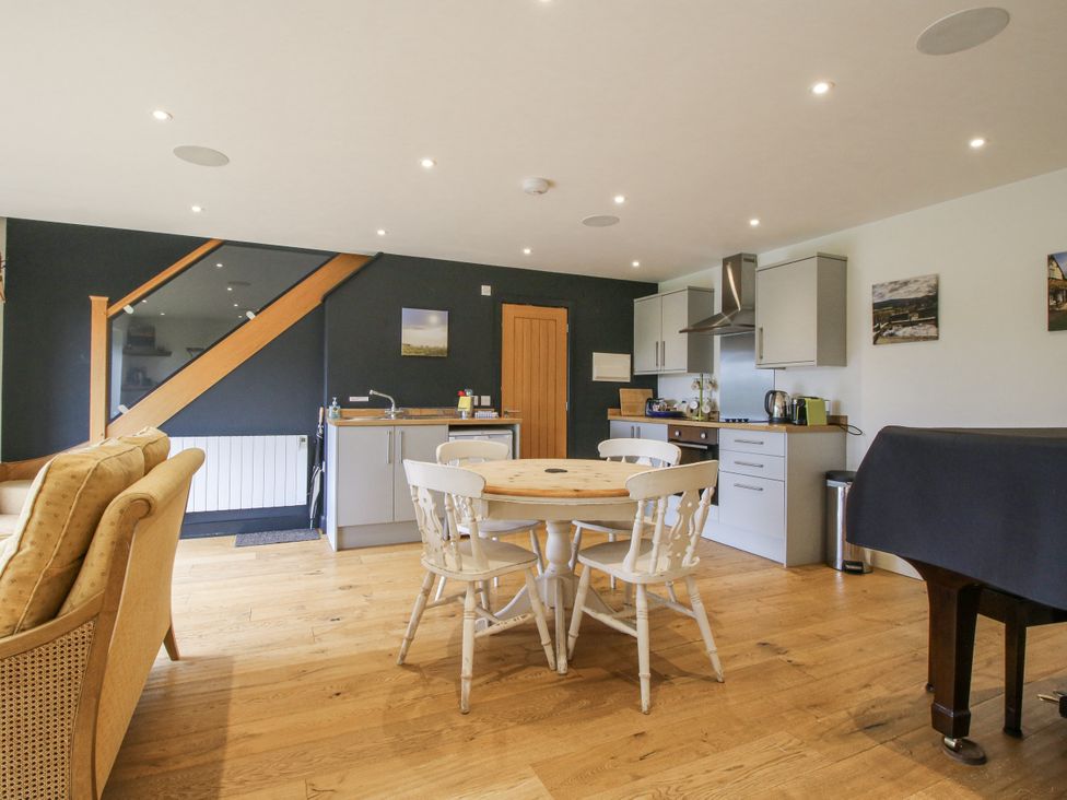 A kitchen with a round table and chairs at Garden Cottage in Wellington Heath near Ledbury