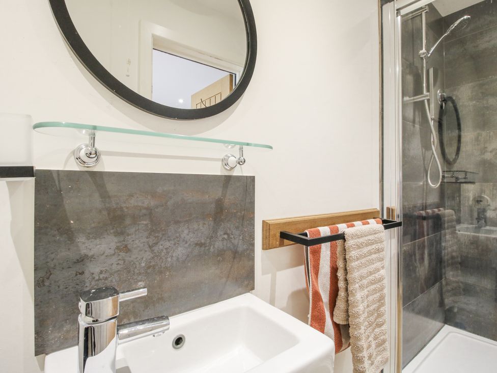 A bathroom with sink and shower at Garden Cottage Wellington Heath near Ledbury