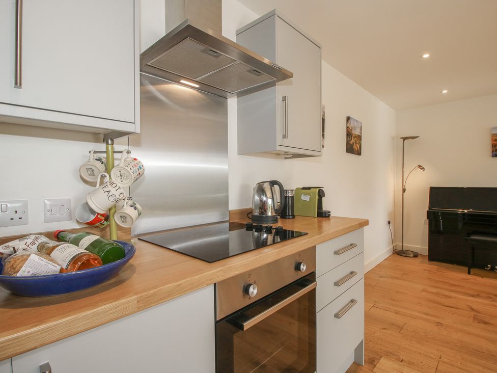 A kitchen with oven, kettle, and cooking items at Garden Cottage in Wellington Heath near Ledbury