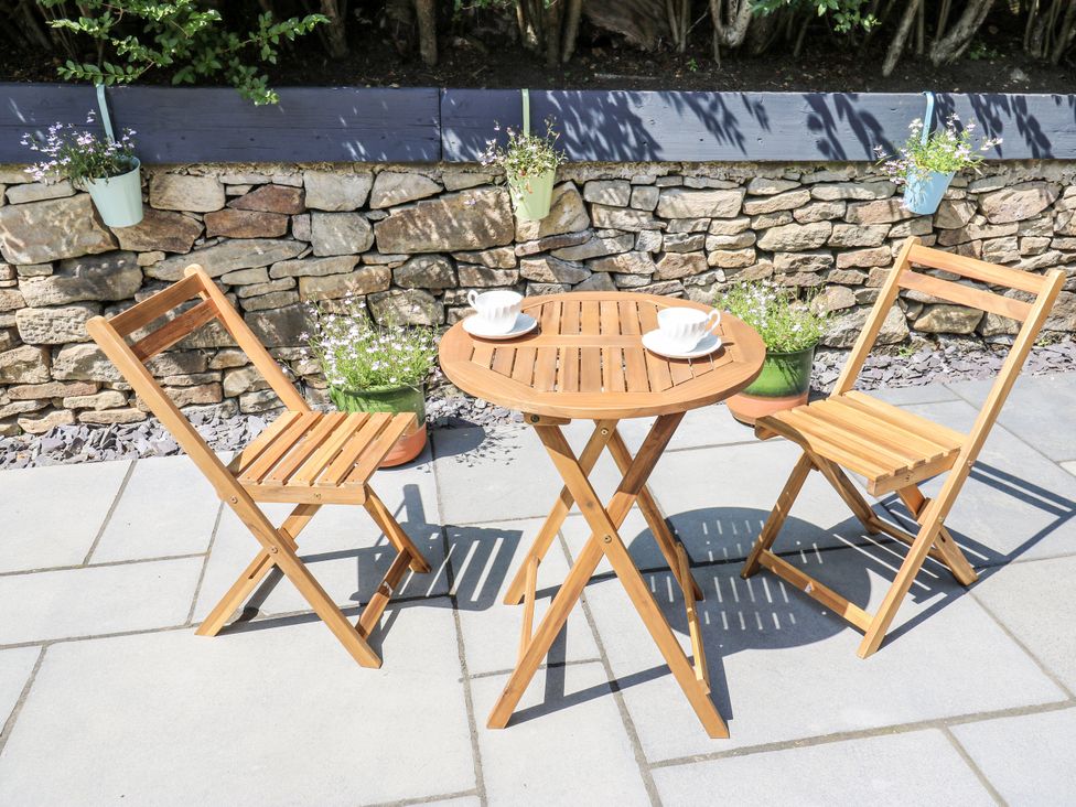 A table and chairs on a patio at Little Birchinlea, Glossop