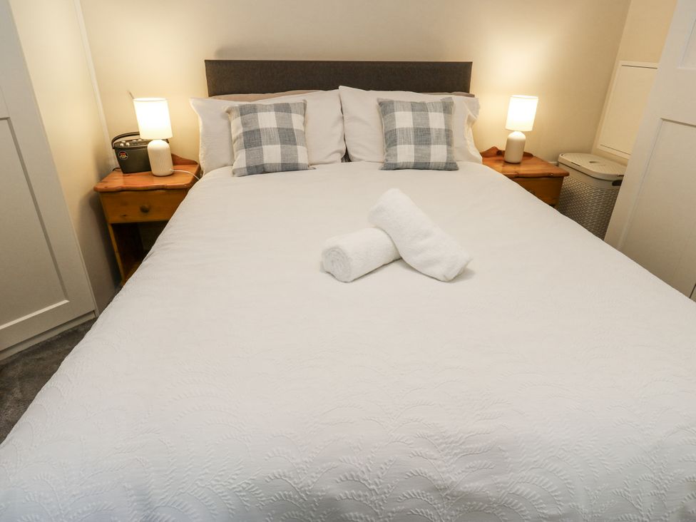 A bedroom with a bed and bedside tables at Little Birchinlea in Glossop