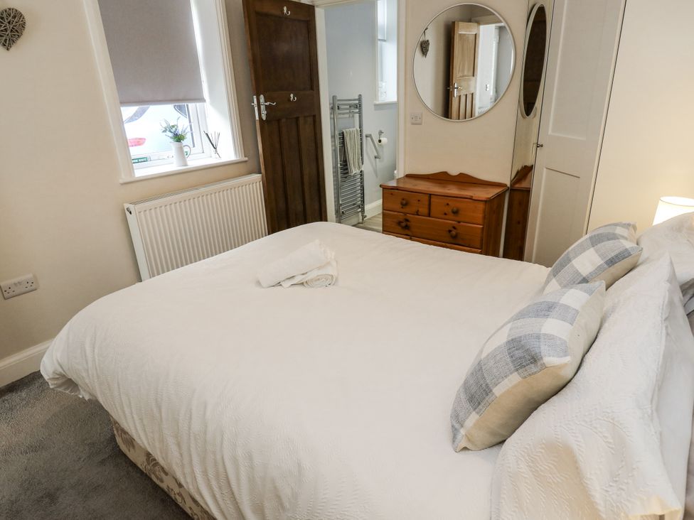 A bedroom with a bed and window at Little Birchinlea Glossop
