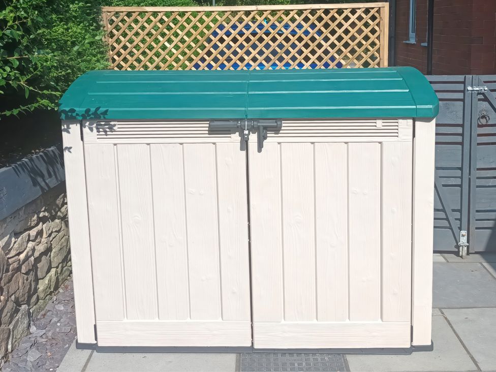 A storage container with a green lid in a garden area at Little Birchinlea Derbyshire