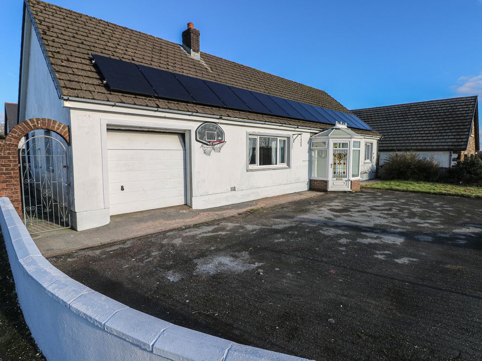 A house with a garage and front garden at Maes Hyfryd in Efailwen near Maenclochog