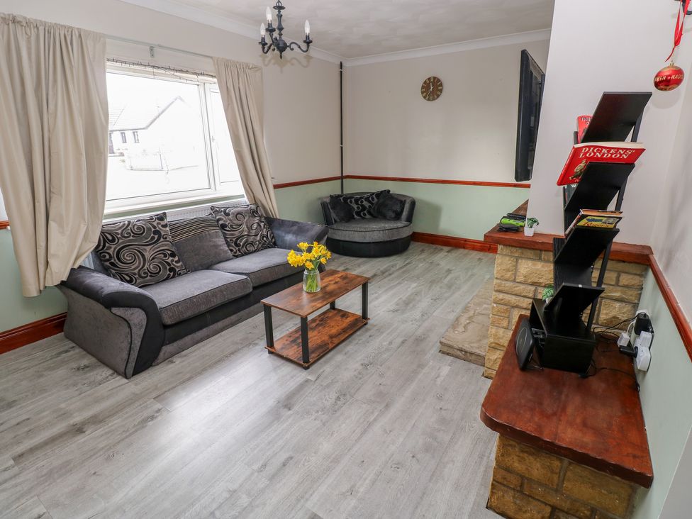 A living room with a sofa and coffee table at Maes Hyfryd in Efailwen near Maenclochog