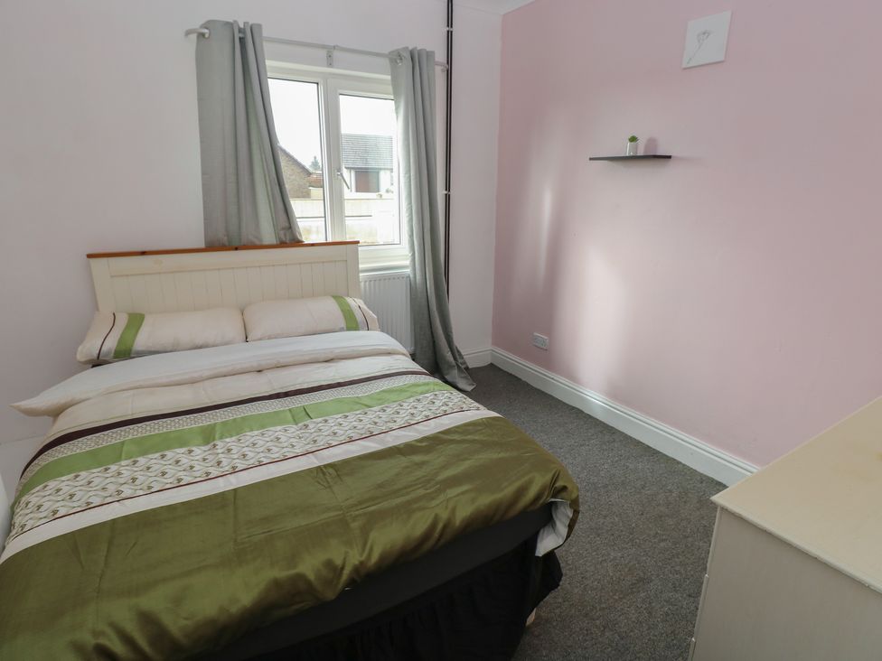 A bedroom with a bed and window at Maes Hyfryd in Efailwen near Maenclochog