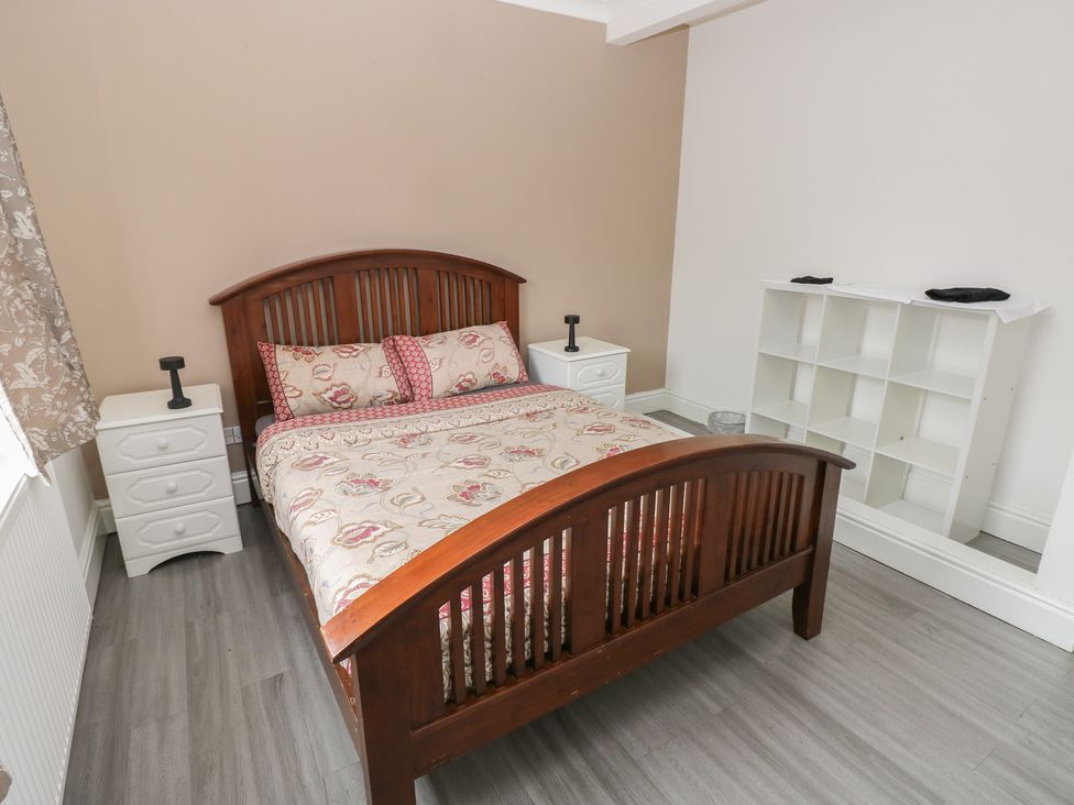 A bedroom with a bed and nightstand at Maes Hyfryd in Efailwen near Maenclochog
