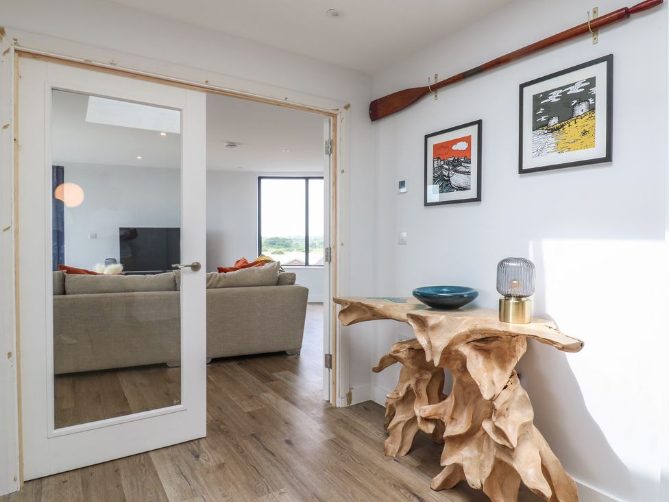 A living room with a door and a wooden table at Flat 4 Hythe