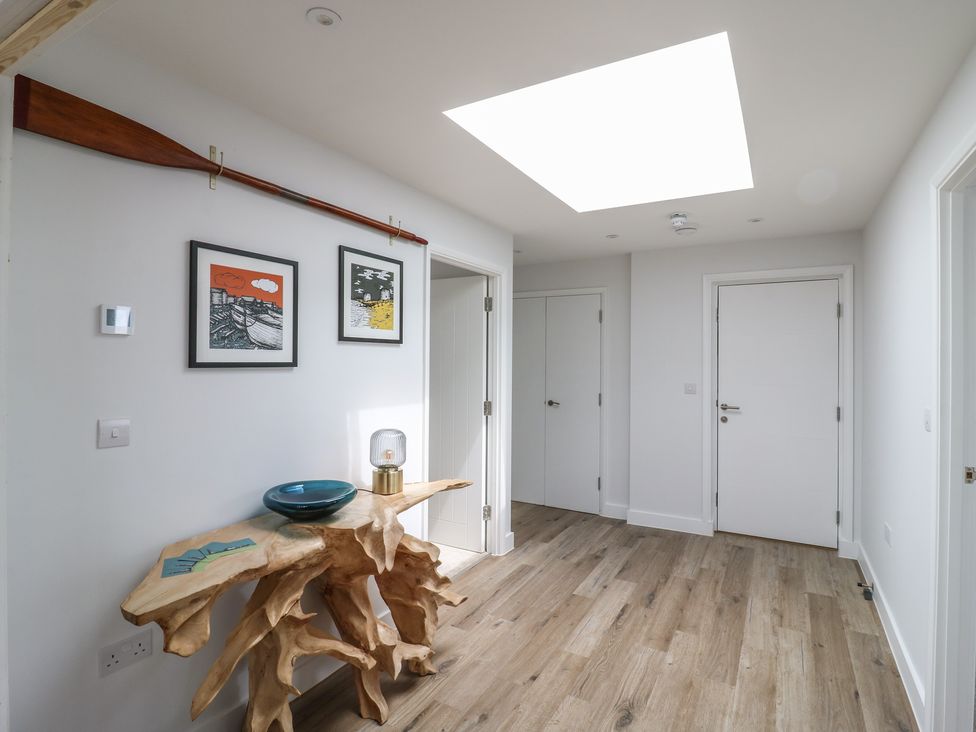 A hallway with wall art and a console table at Flat 4 in Hythe