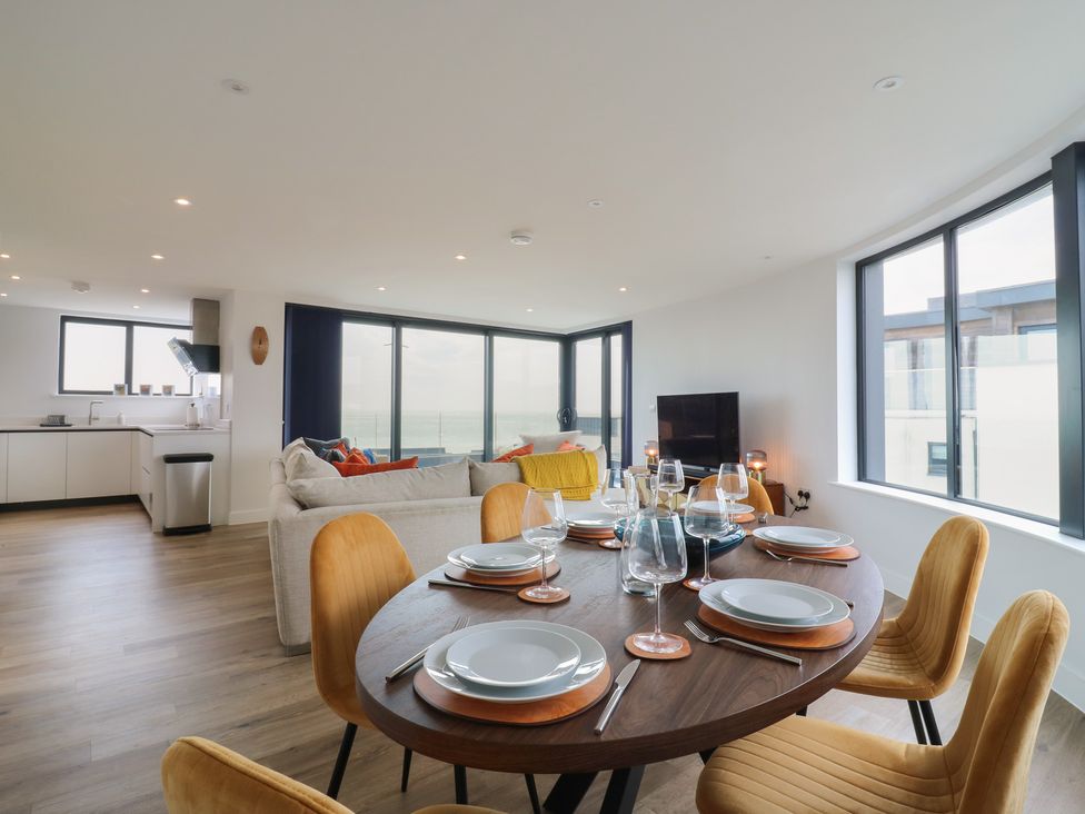 A dining room with a table set for dinner at Flat 4 in Hythe
