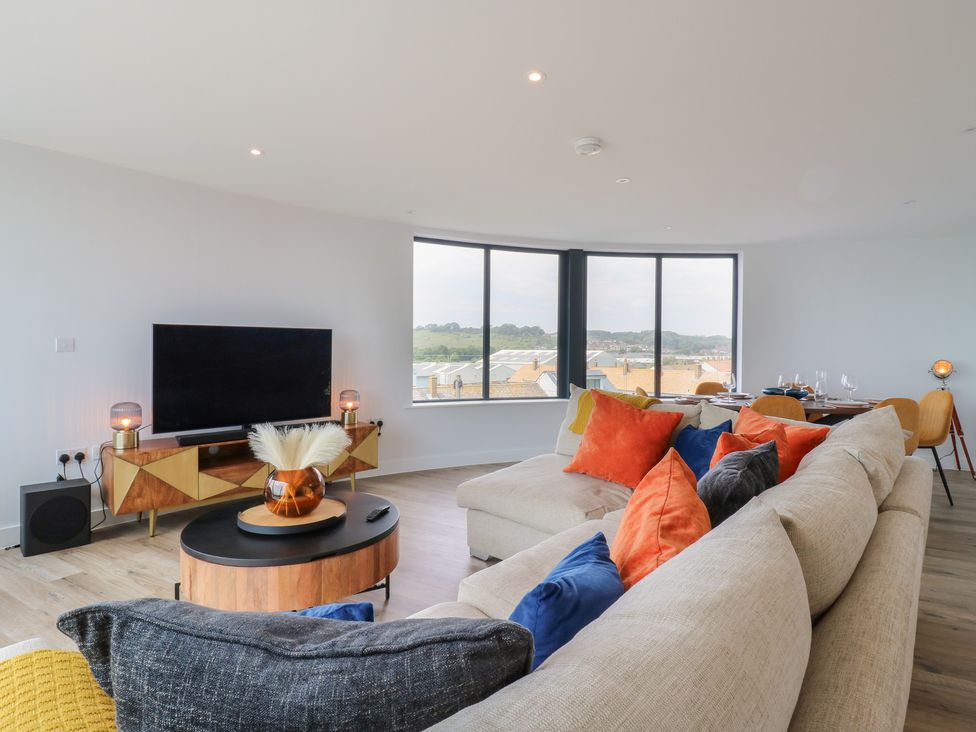 A living room with a television and coffee table at Flat 4 in Hythe