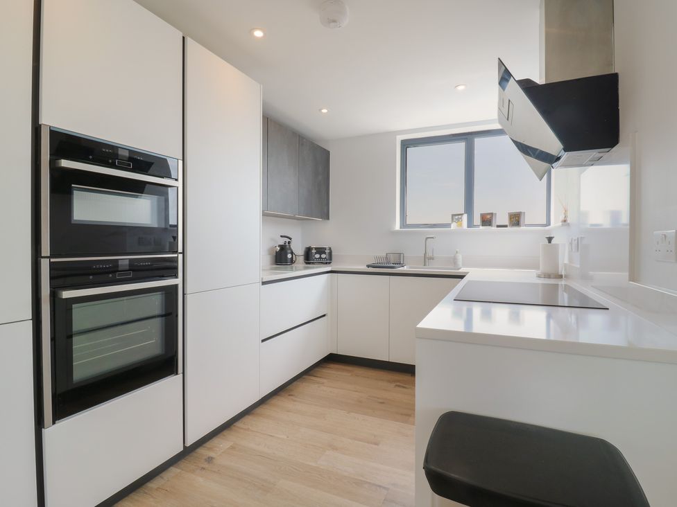 A kitchen with cabinets, oven, and sink at Flat 4 in Hythe