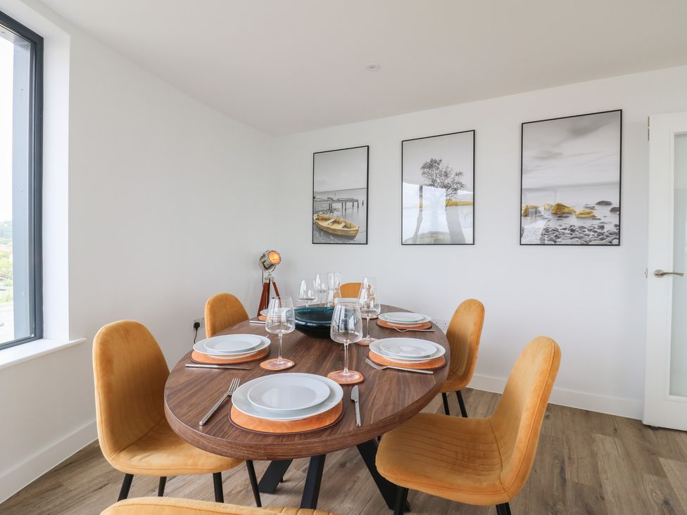 A dining room with a round table and chairs at Flat 4 in Hythe