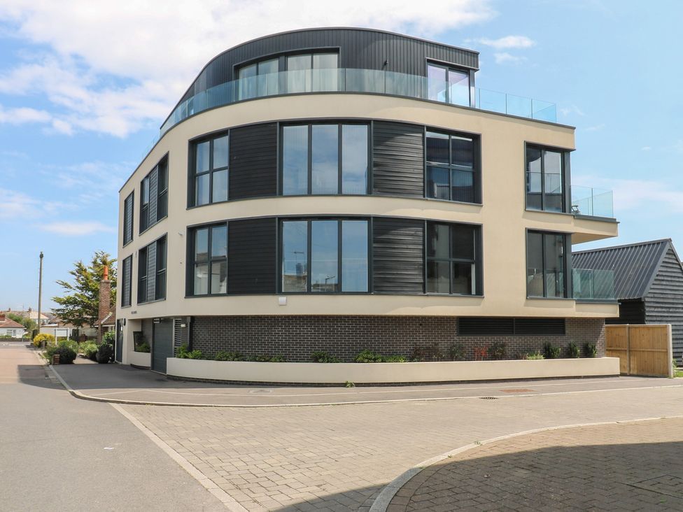 A modern building with large windows and balconies at Flat 4 in Hythe