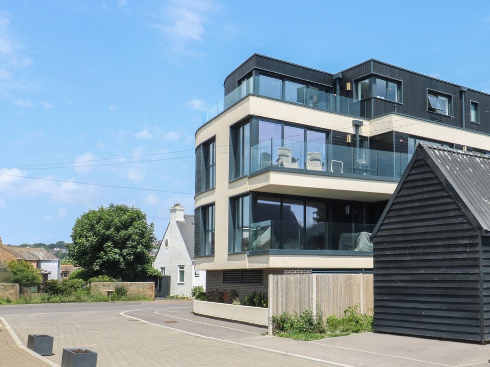 A modern building with a balcony and a shed at Flat 4 in Hythe