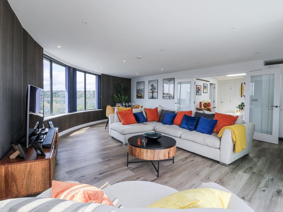 A living room with a sofa and a television at Flat 4 in Hythe