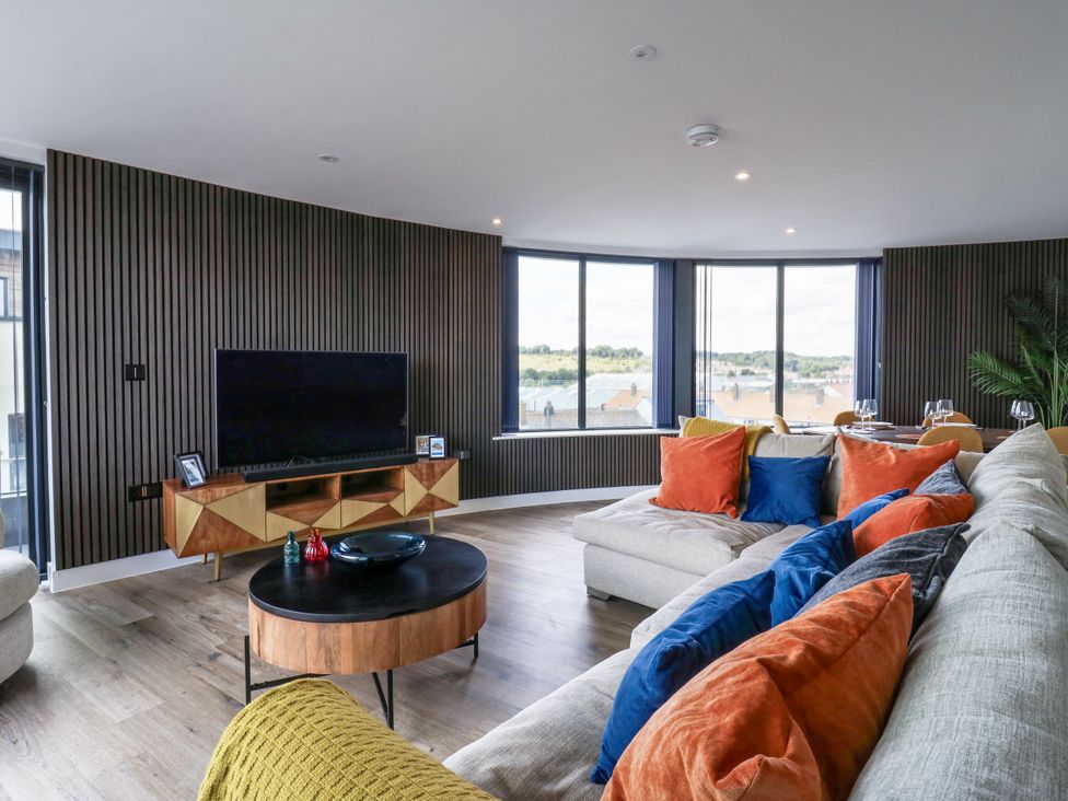 A living room with a television and sofa at Flat 4 in Hythe