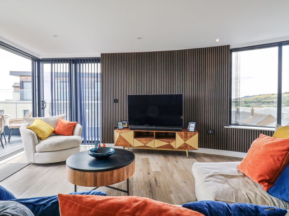 A living room with a sofa and television at Flat 4 in Hythe
