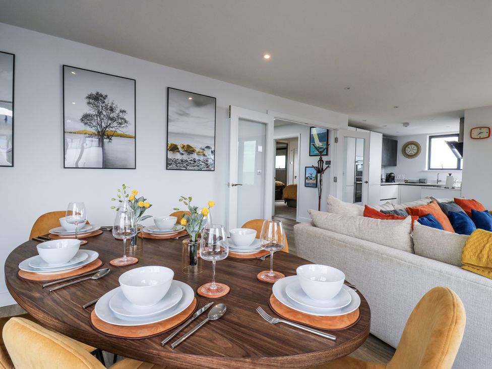 A dining room with a table set for meals at Flat 4 in Hythe