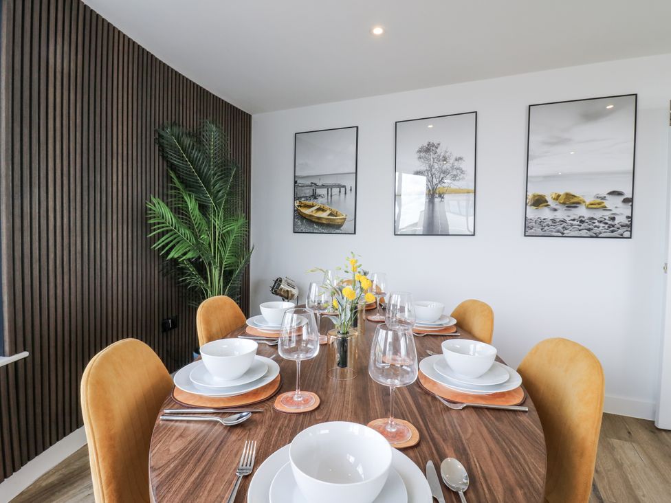 A dining room with a table set for a meal at Flat 4 in Hythe