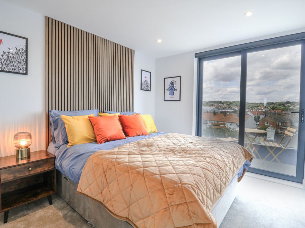 A bedroom with a bed and bedside table at Flat 4 in Hythe