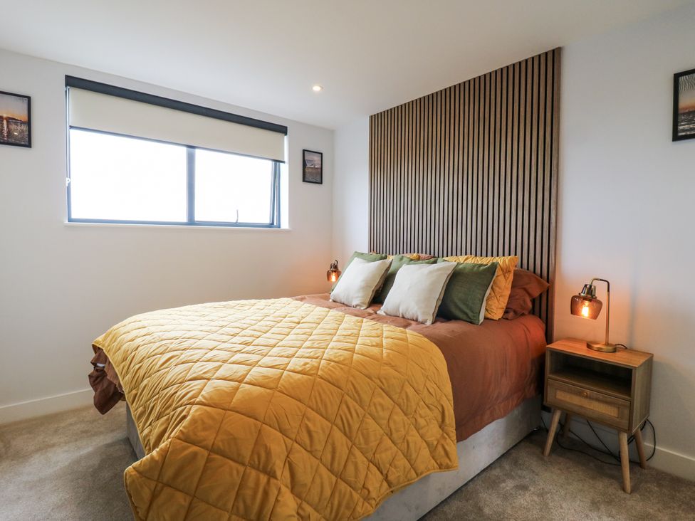 A bedroom with a bed and bedside table at Flat 4 in Hythe