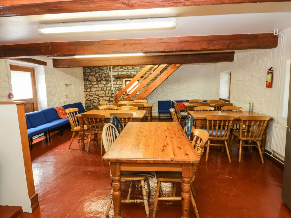 A dining room with tables and chairs at West Barn