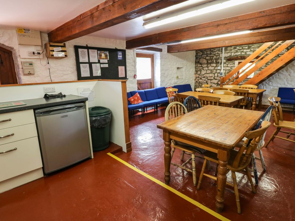 A dining room with tables and chairs at West Barn