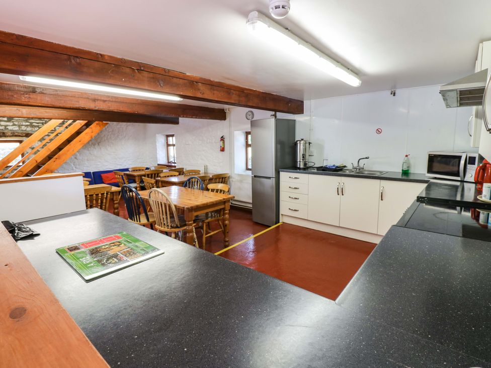 A kitchen with table and chairs at West Barn