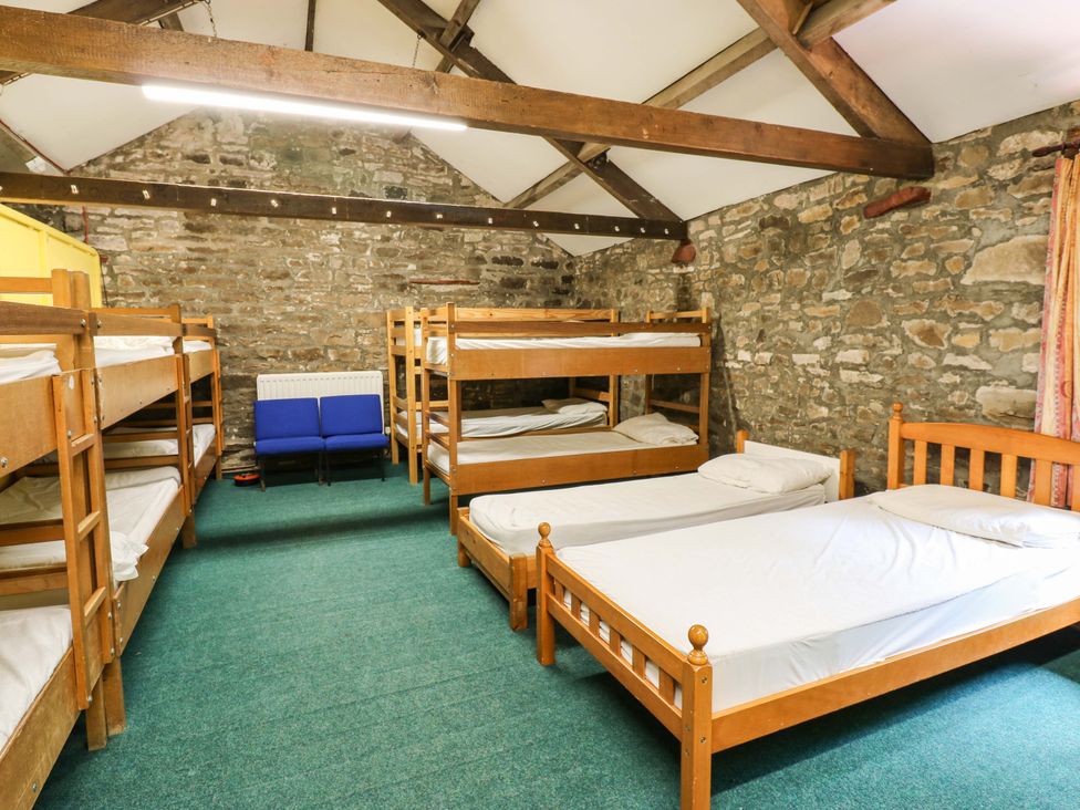 A dormitory with bunk beds and chairs at West Barn